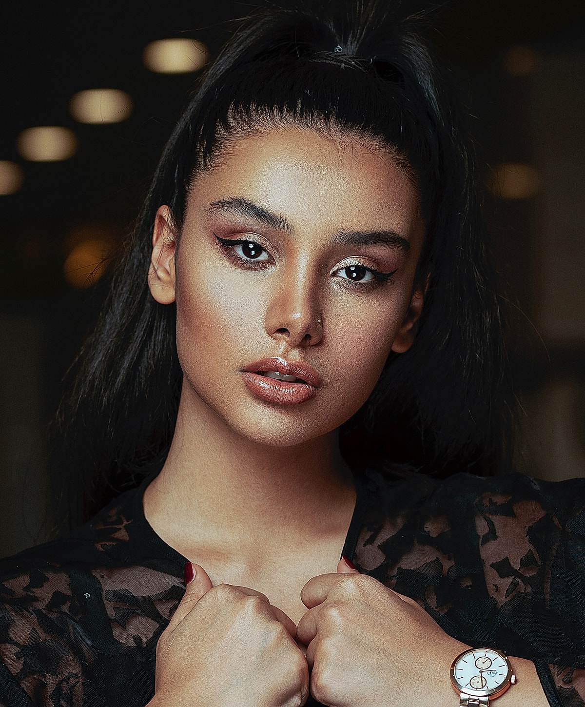 Portrait of a woman with elegant makeup and watch.
