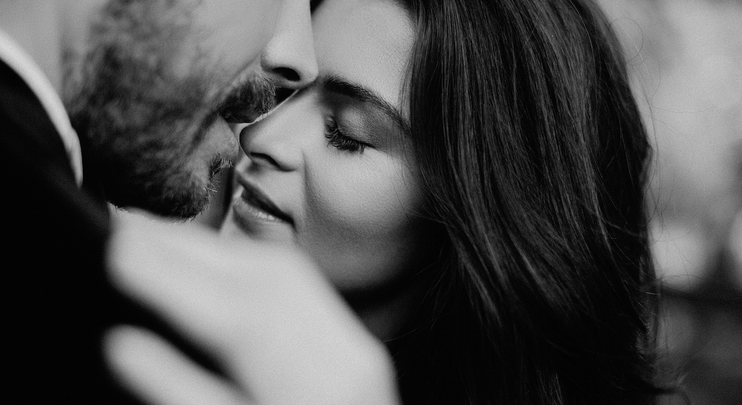 Couple sharing an intimate moment in black and white.